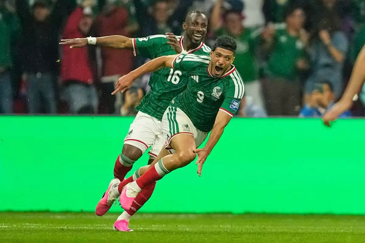 Mexico's Raul Jimenez (9) celebrates with teammate Julian Quinones (16) after scoring his team's second goal during the World Cup round of 32 soccer match between Mexico and Ecuador in Mexico City, Tuesday, June 30, 2026. (AP Photo/Natacha Pisarenko)
