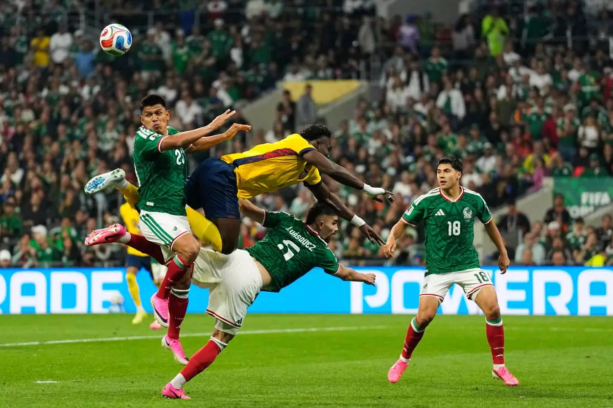 Mexico's Jesus Gallardo, left, jumps for the ball with Ecuador's Jordy Caicedo during the World Cup round of 32 soccer match in Mexico City, Tuesday, June 30, 2026. (AP Photo/Ricardo Mazalan)