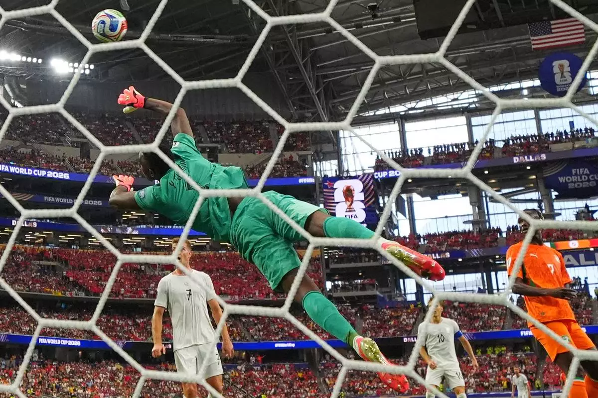 Norway's Antonio Nusa (20) scores their opening goal past Ivory Coast goalkeeper Yahia Fofana (1) during the World Cup round of 32 soccer match between Ivory Coast and Norway in Arlington, Texas, near Dallas, Tuesday, June 30, 2026. (AP Photo/Julio Cortez)