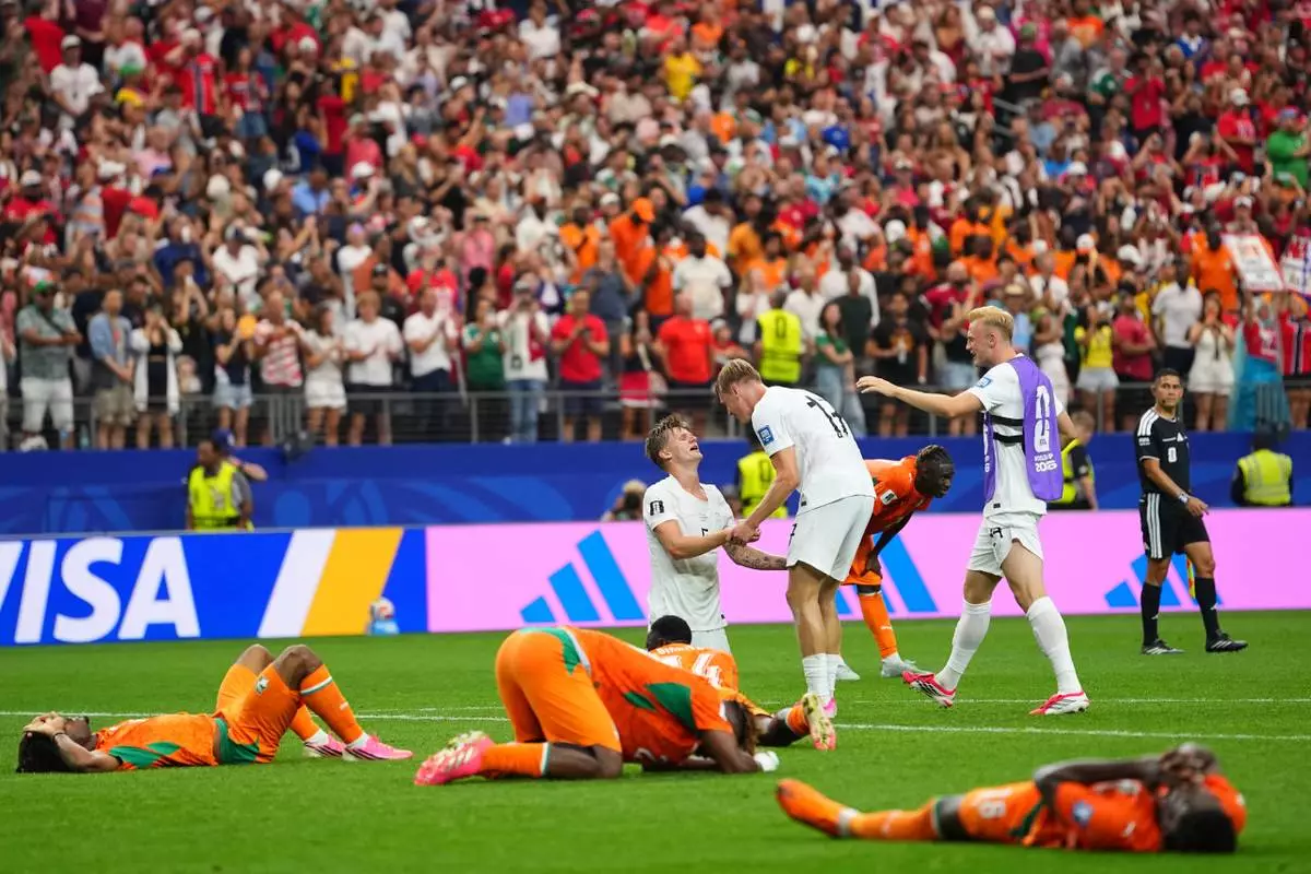 Norway's David Moeller Wolfe (5) and Torbjoern Heggem (17) celebrate as Ivory Coast players lie on the pitch, after the World Cup round of 32 soccer match between Ivory Coast and Norway in Arlington, Texas, near Dallas, Tuesday, June 30, 2026. (AP Photo/Julio Cortez)