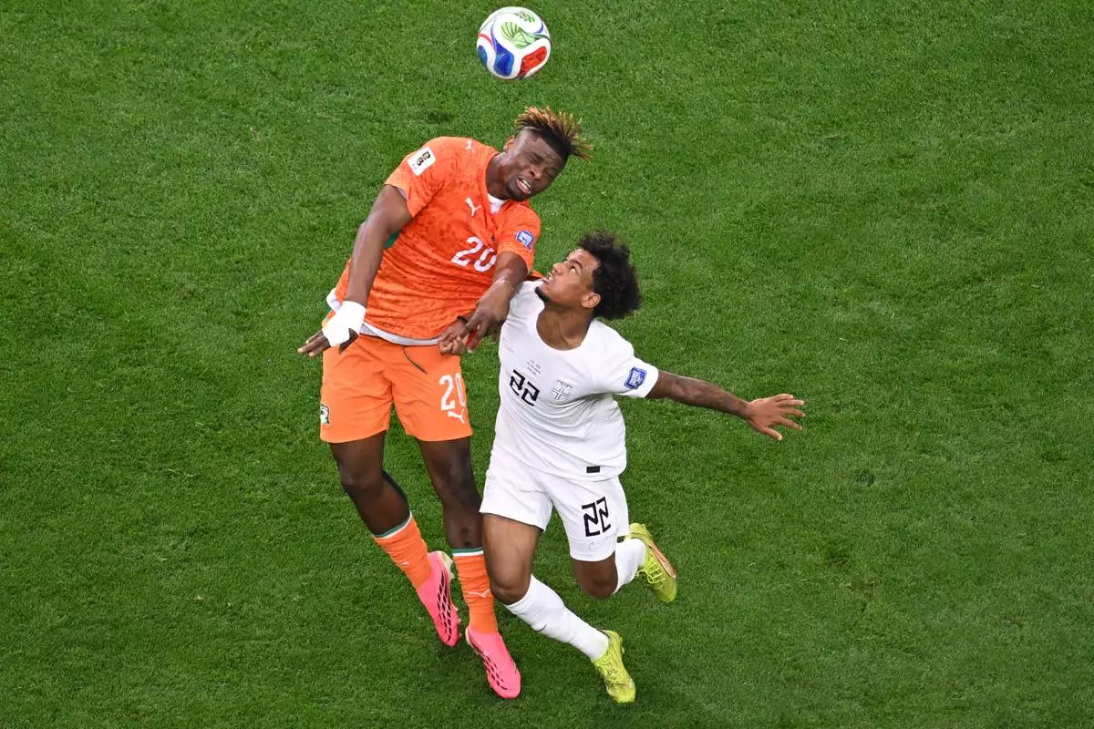 Ivory Coast's Emmanuel Agbadou (20) and Norway's Oscar Bobb (22) jump for the ball during the World Cup round of 32 soccer match between Ivory Coast and Norway in Arlington, Texas, near Dallas, Tuesday, June 30, 2026. (AP Photo/Jessica Tobias)
