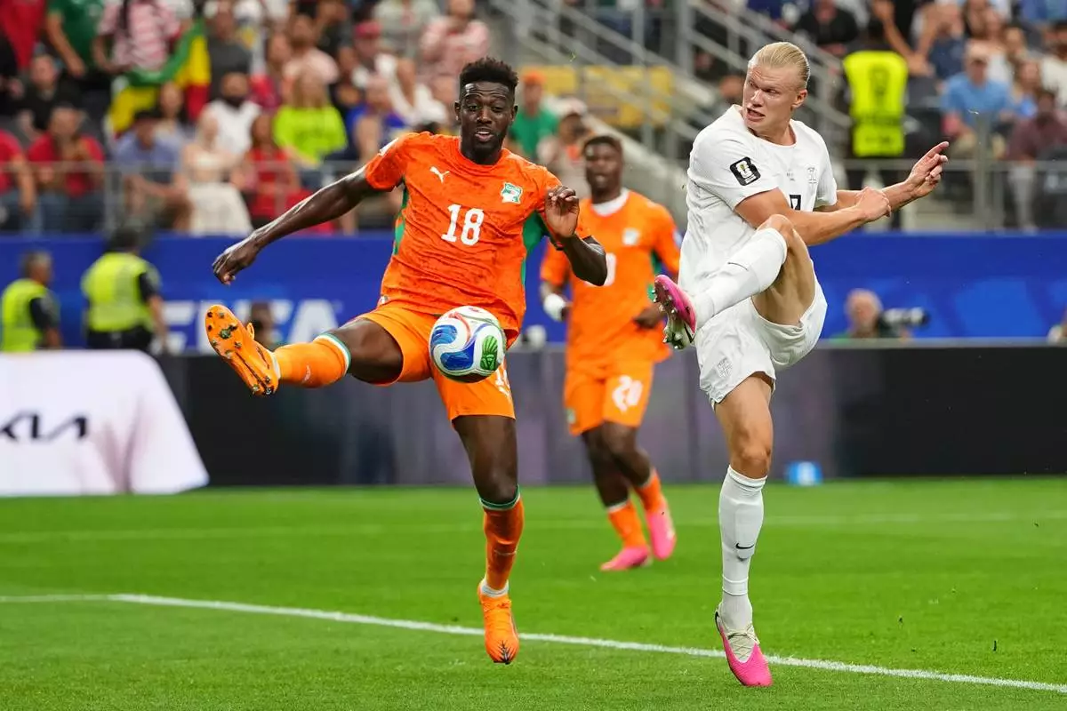 Norway's Erling Haaland (9) kicks the ball past Ivory Coast's Ibrahim Sangare (18) during the World Cup round of 32 soccer match between Ivory Coast and Norway in Arlington, Texas, near Dallas, Tuesday, June 30, 2026. (AP Photo/Julio Cortez)