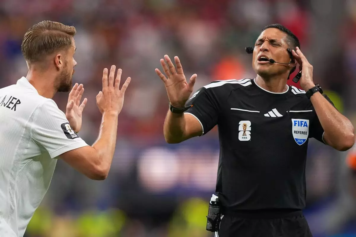 Norway's Kristoffer Ajer (3) argues with referee Jesus Valenzuela Saez, of Venezuela, during the World Cup round of 32 soccer match between Ivory Coast and Norway in Arlington, Texas, near Dallas, Tuesday, June 30, 2026. (AP Photo/Julio Cortez)