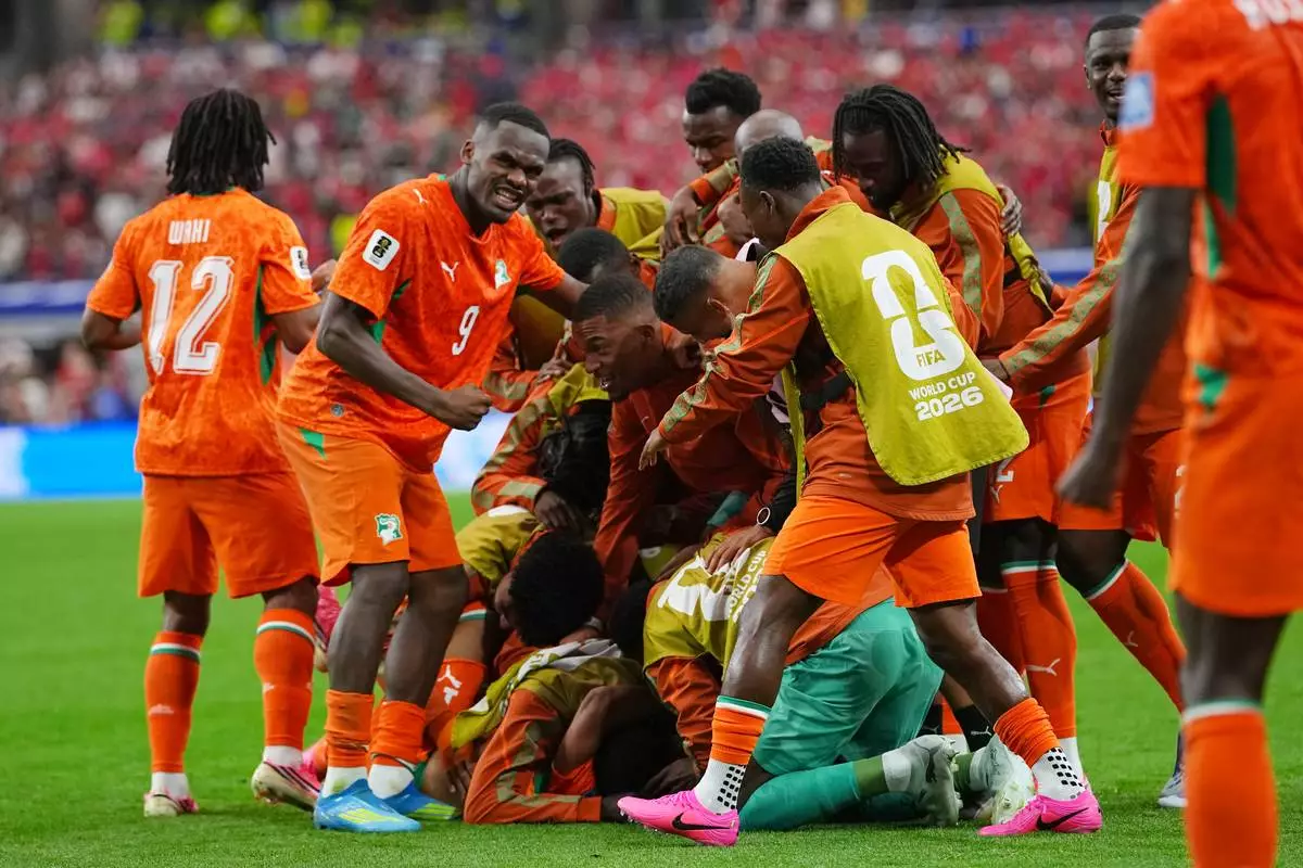 Ivory Coast's Amad Diallo (15) celebrates with teammates after scoring his side's opening goal during the World Cup round of 32 soccer match between Ivory Coast and Norway in Arlington, Texas, near Dallas, Tuesday, June 30, 2026. (AP Photo/Julio Cortez)