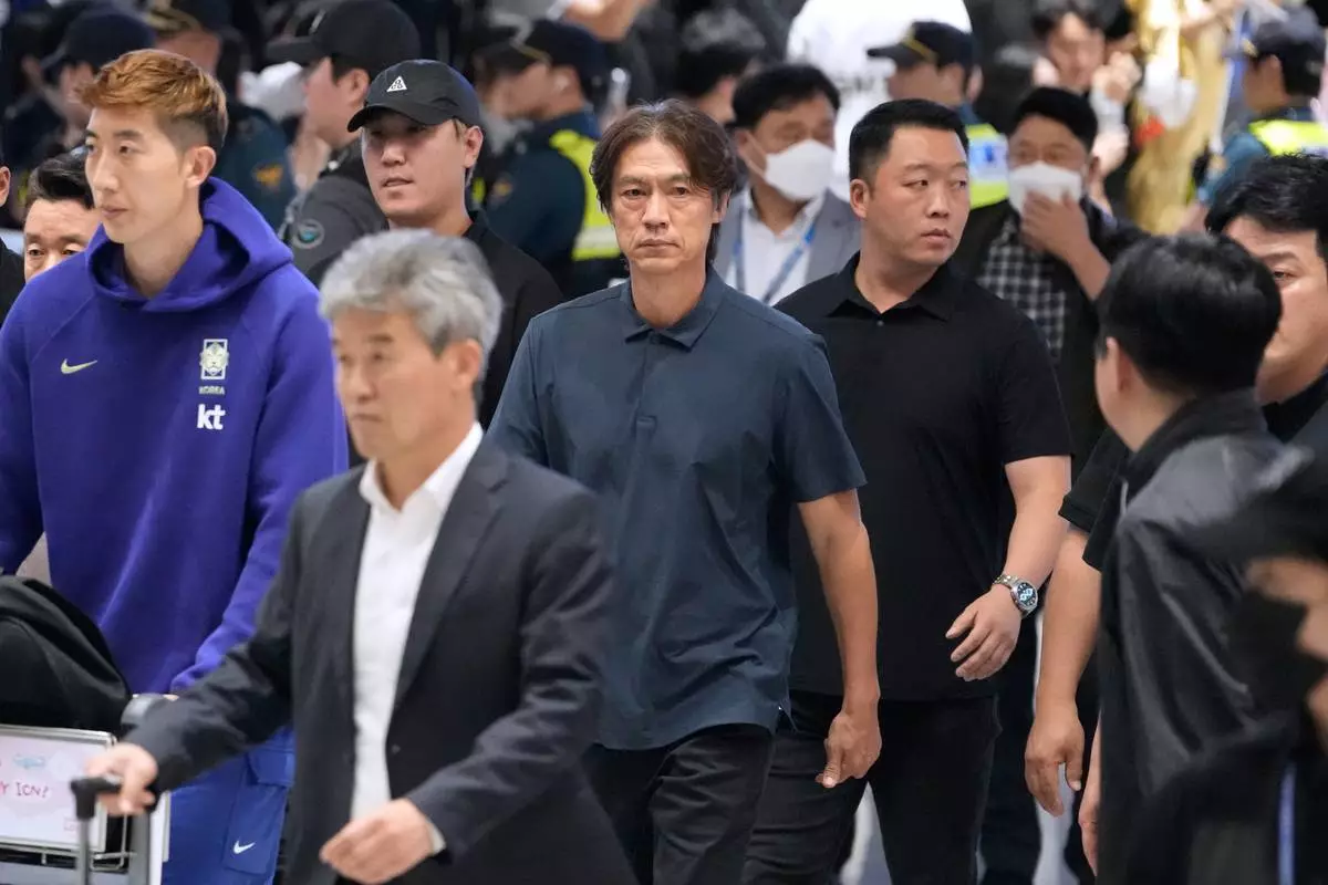 South Korea's soccer head coach Hong Myung-bo, center, who has resigned following the team's early elimination from the World Cup, arrives at the Incheon International Airport in Incheon, South Korea, Tuesday, June 30, 2026. (AP Photo/Ahn Young-joon)