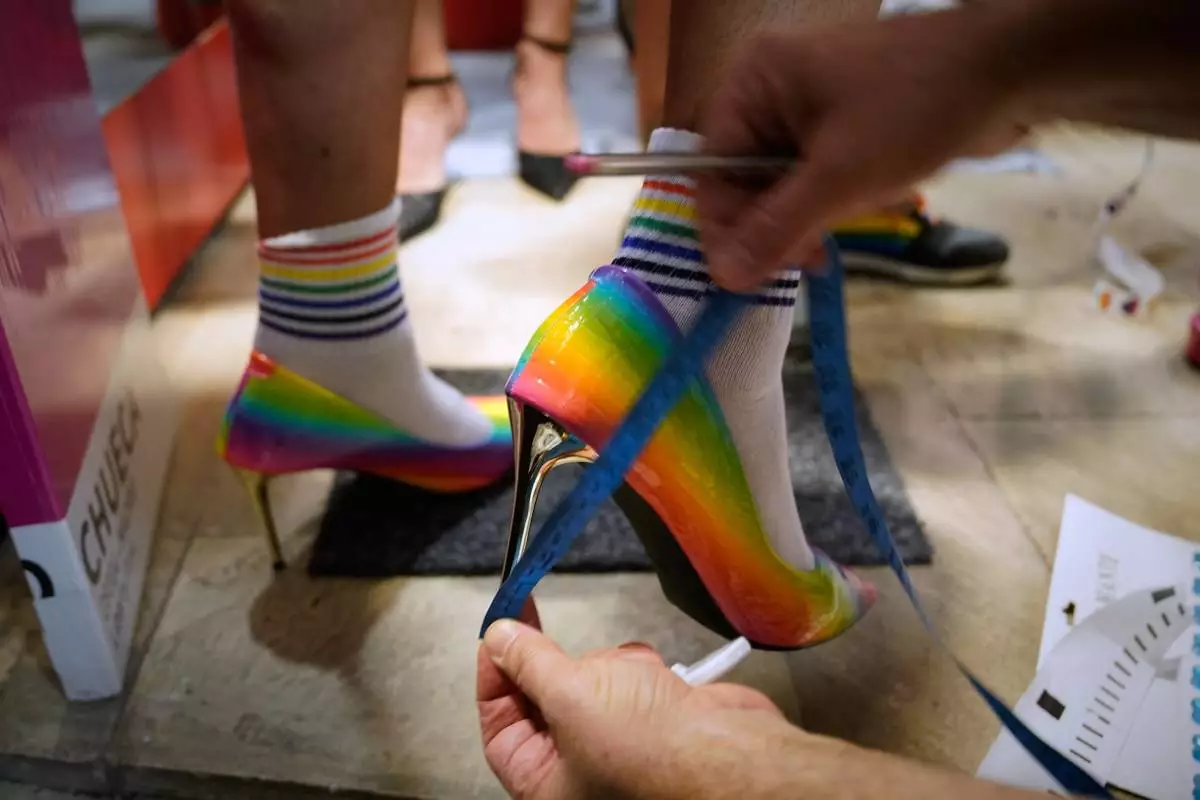 Participants prepare to take part in the annual high-heel race during Madrid Pride Week, in Madrid, Thursday, July 2, 2026. (AP Photo/Andrea Comas)