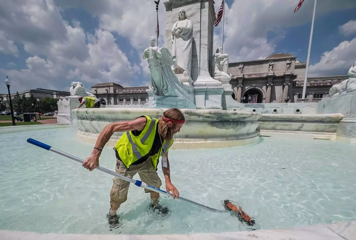 Jeffrey Holt Adcock maintains the fountains at Union Station in Washington, Wednesday, July 1, 2026. (AP Photo/J. Scott Applewhite)