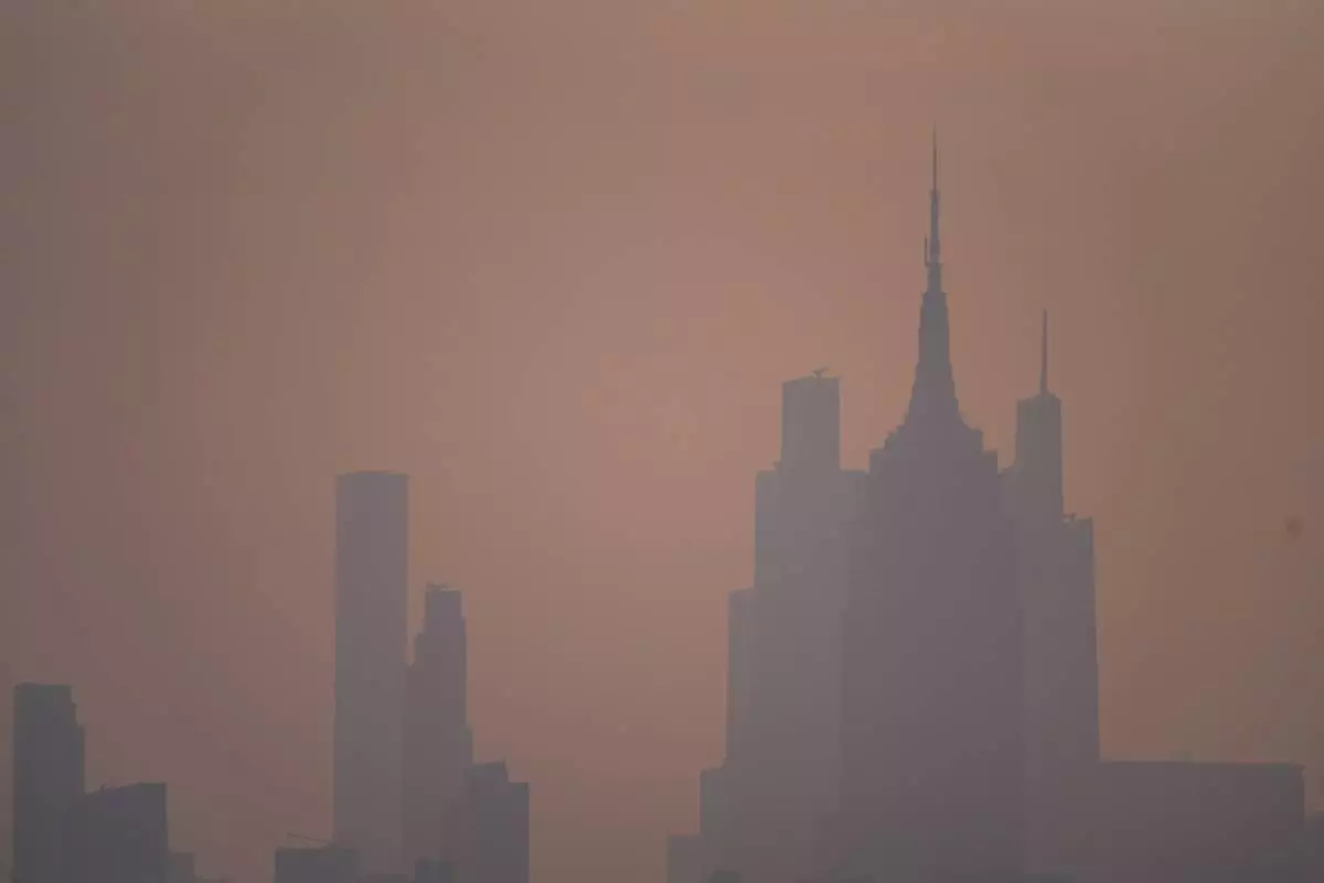 The New York City skyline is seen through a cover of wildfire smoke, in Jersey City, N.J., Friday, July 17, 2026. (AP Photo/Ryan Murphy)