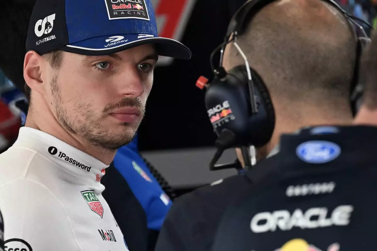 Red Bull driver Max Verstappen of the Netherlands, left, prepares for the qualifying session ahead of the British F1 Grand Prix, in Silverstone, England, Saturday, July 4, 2026. (Peter Powell/Pool via AP)