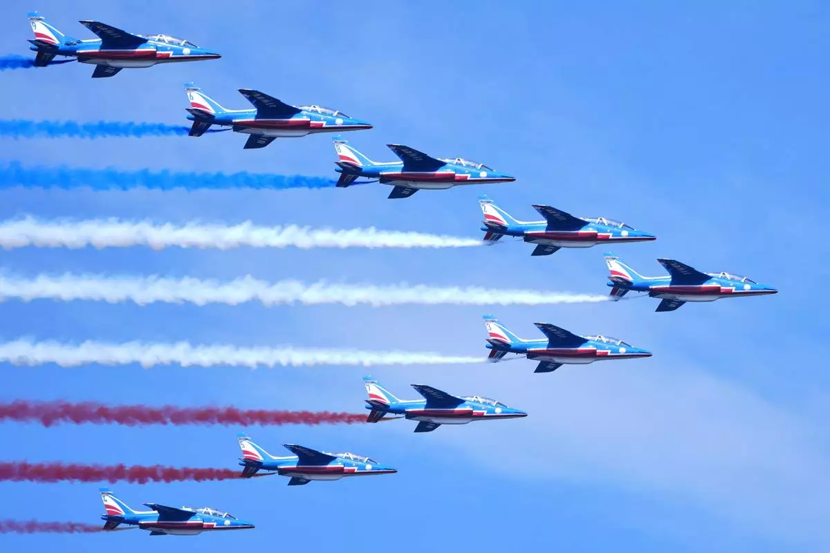 The French Air Force acrobatic squad Patrouille de France perform a flyover during the International Aerial Review, Saturday, July 4, 2026, in New York. (AP Photo/Sydney Schaefer)