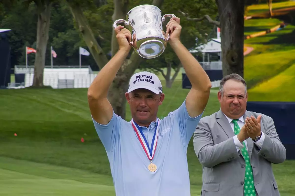 Padraig Harrington lifts up the Francis D. Ouimet Memorial Trophy after winning the U.S. Senior Open at Scioto Country Club in Columbus, Ohio, on July 5, 2026. (AP Photo/Joe Reedy)