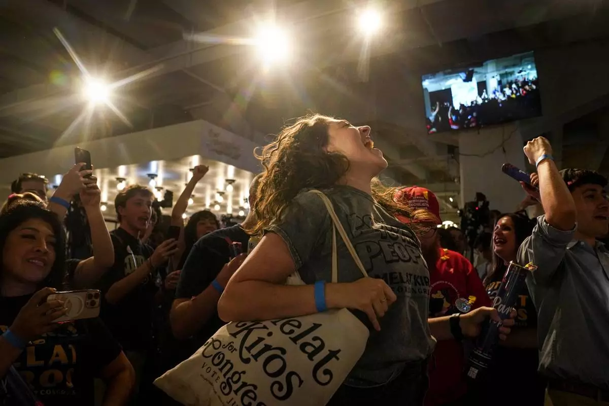 Nikita Valdez jumps while cheering after the first report of the election results show Democratic congressional candidate Melat Kiros in the lead during a primary election night watch party at The Broadway, Tuesday, June 30, 2026, in Denver. (AP Photo/Rebecca Slezak)
