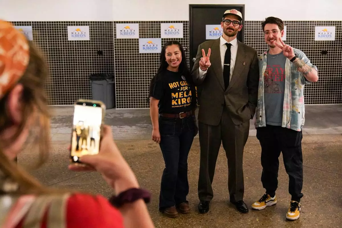 Hasan Piker, center, takes a photo with Dolfin Olsen and Micah Stemm-Wolf at Democratic congressional candidate Melat Kiros' primary election night watch party, at The Broadway, Tuesday, June 30, 2026, in Denver. (AP Photo/Rebecca Slezak)