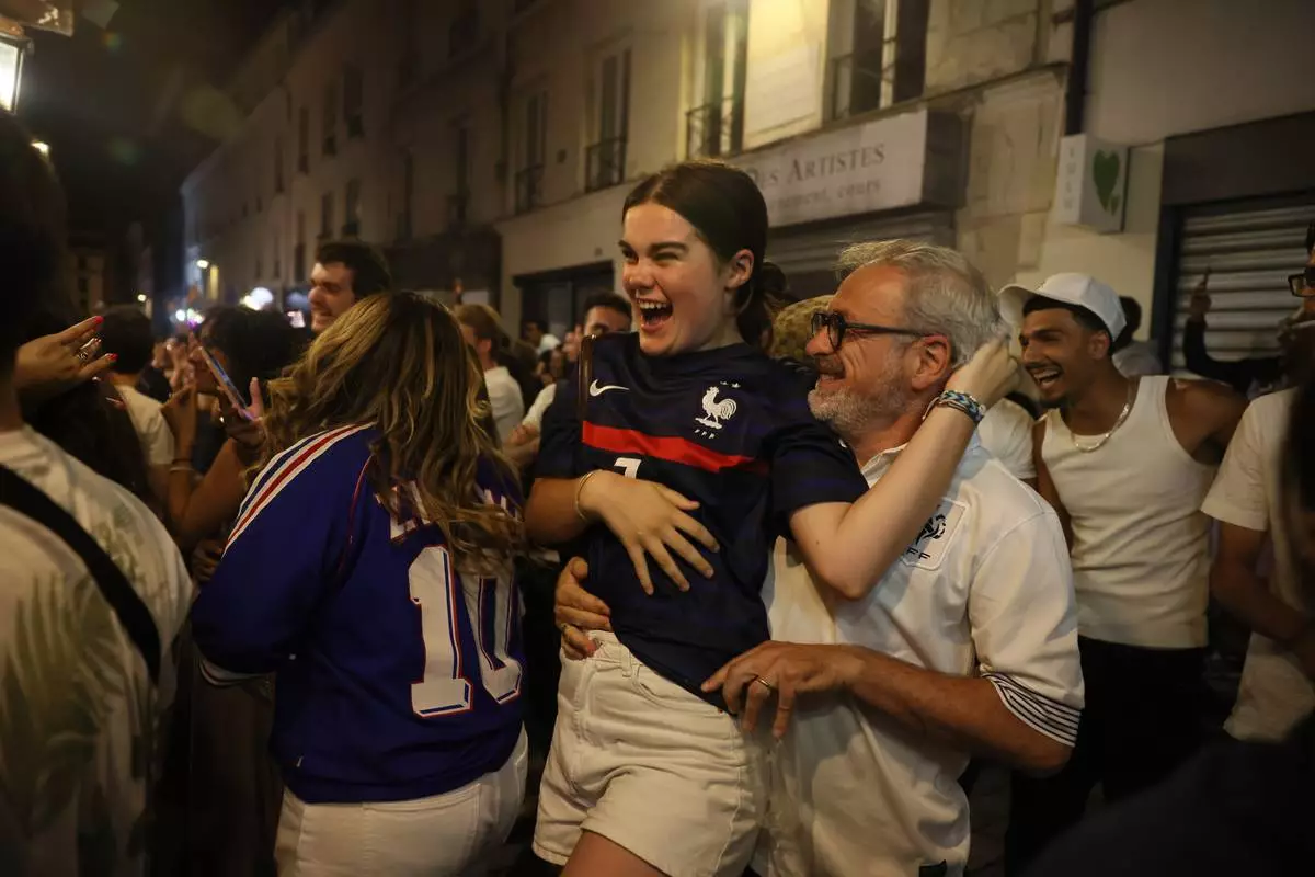 French fans react as they watch a broadcast of the World Cup quarterfinal soccer match between France and Morocco, Thursday, July 9, 2026, in Paris. (AP Photo/Thomas Padilla)