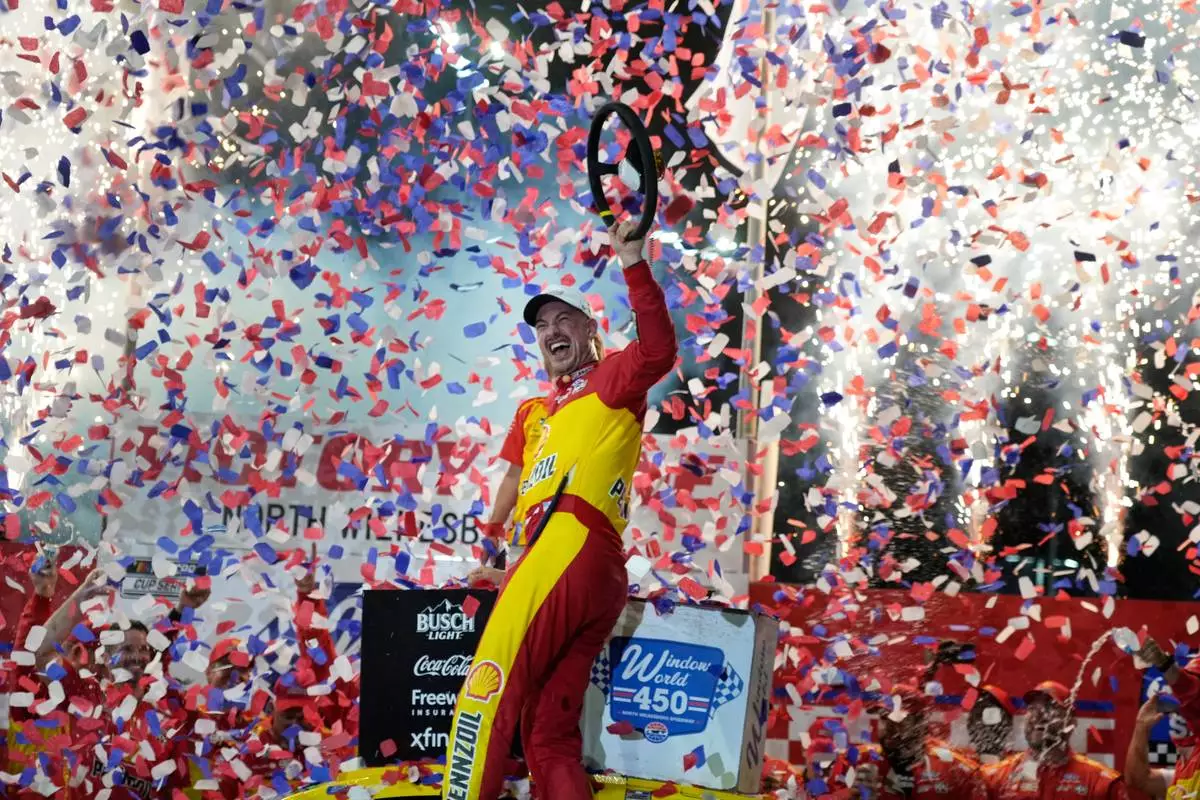Joey Logano celebrates in Victory Lane after winning a NASCAR Cup Series auto race in North Wilkesboro, N.C., Sunday, July 19, 2026. (AP Photo/Chuck Burton)