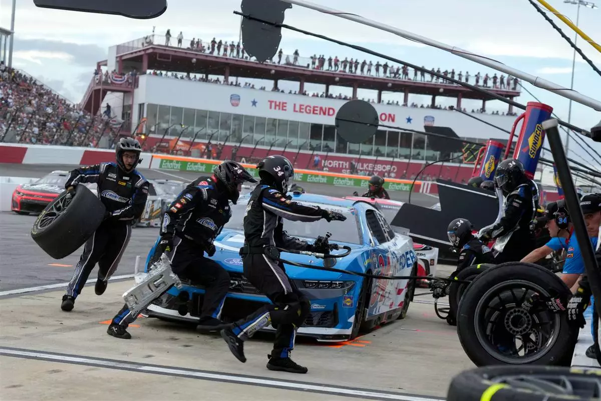 Drivers perform a pit stop on driver Todd Gilliland's car during a NASCAR Cup Series auto race in North Wilkesboro, N.C., Sunday, July 19, 2026. (AP Photo/Chuck Burton)
