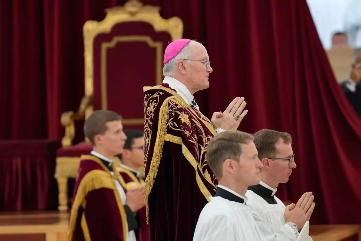 Bishop Bernard Fellay prays during the consecration ceremony for four new bishops in a tent set up outside the Society of St. Pius X seminary, in Econe, Switzerland, Wednesday, July 1, 2026. (AP Photo/Baz Ratner)