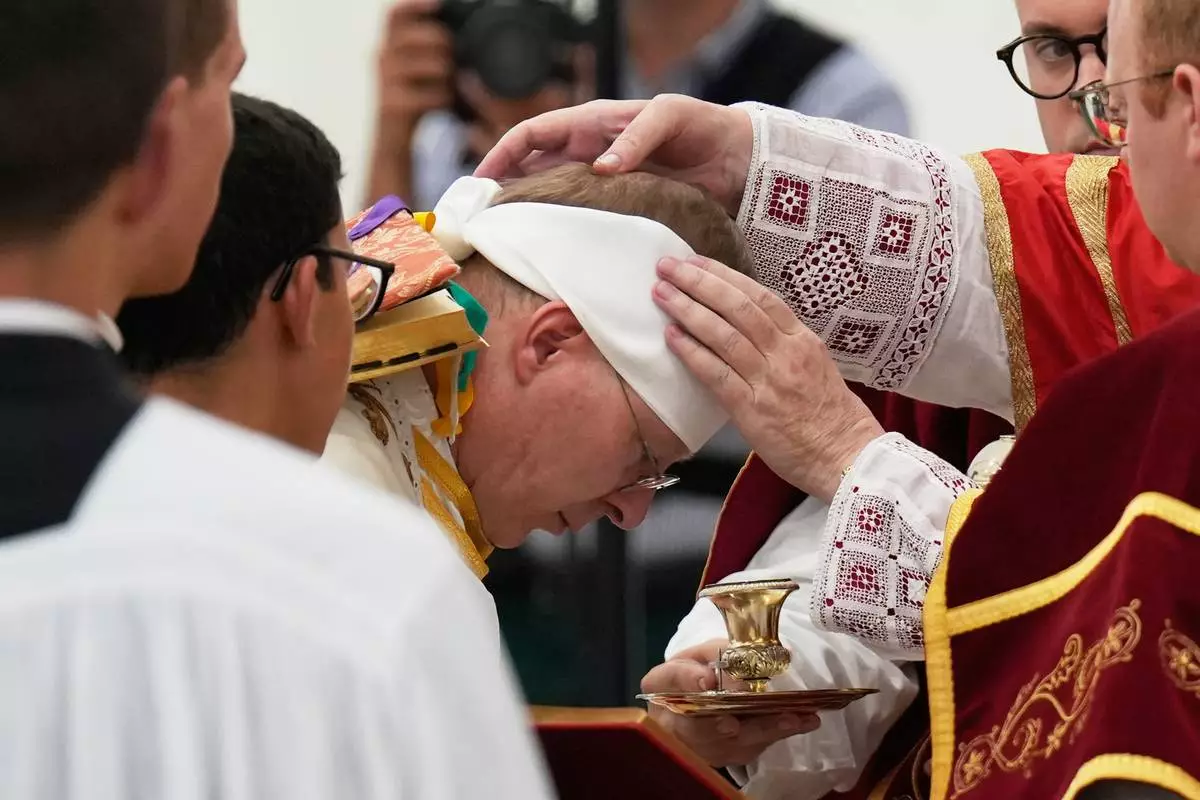 Father Pascal Schreiber is consecrated as bishop during a ceremony in a tent set up outside the Society of St. Pius X seminary in Econe, Switzerland, Wednesday, July 1, 2026. (AP Photo/Baz Ratner)