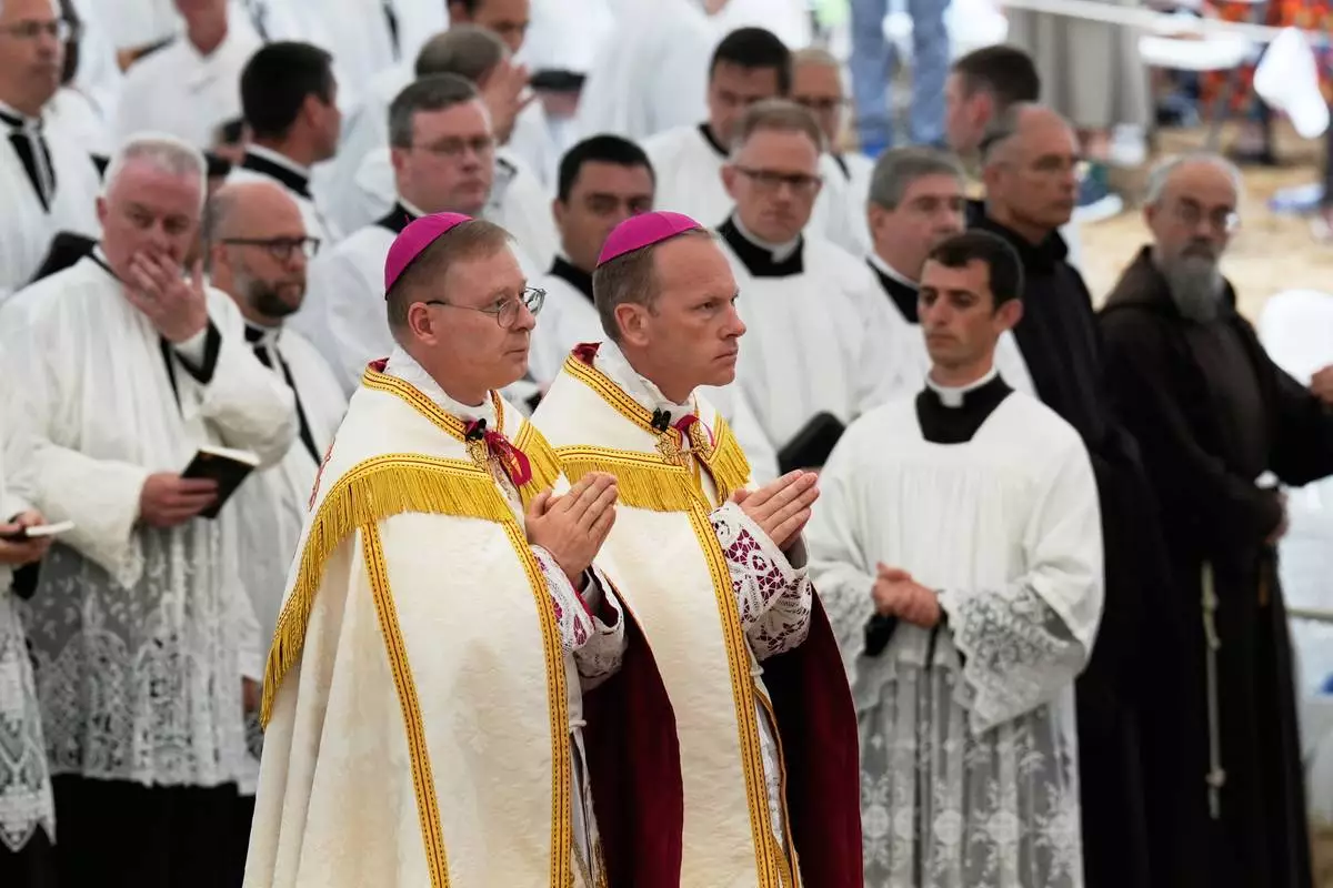 Father Pascal Schreiber, left, and father Michael Goldade arrive for their consecration ceremony as bishops in a tent set up outside the Society of St. Pius X seminary, in Econe, Switzerland, Wednesday, July 1, 2026. (AP Photo/Baz Ratner)