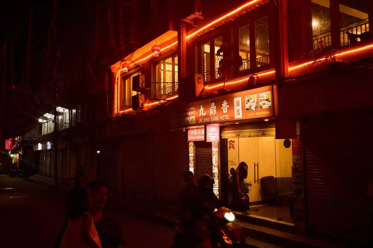 A person enters a hotel where many sex workers meet clients in Kathmandu, Nepal, Friday, May 22, 2026. (AP Photo/Bram Janssen)
