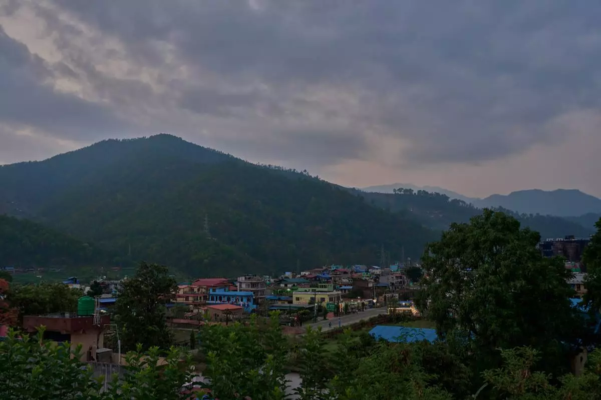 Colorful buildings sit along a main road in Hetauda, Nepal, Thursday, May 14, 2026. (AP Photo/Bram Janssen)