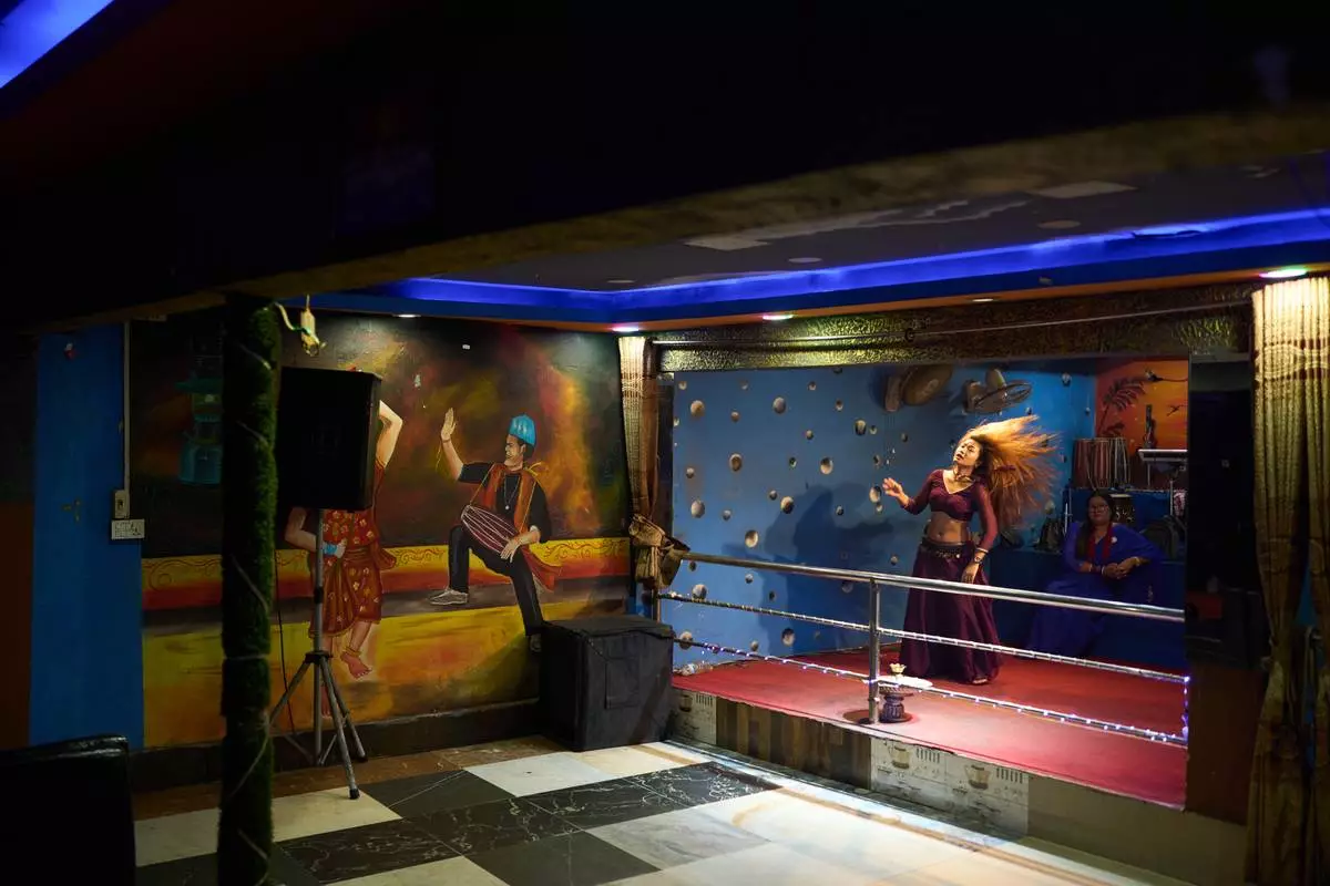 A dancer performs in a club in Hetauda, Nepal, Saturday, May 16, 2026. (AP Photo/Bram Janssen)