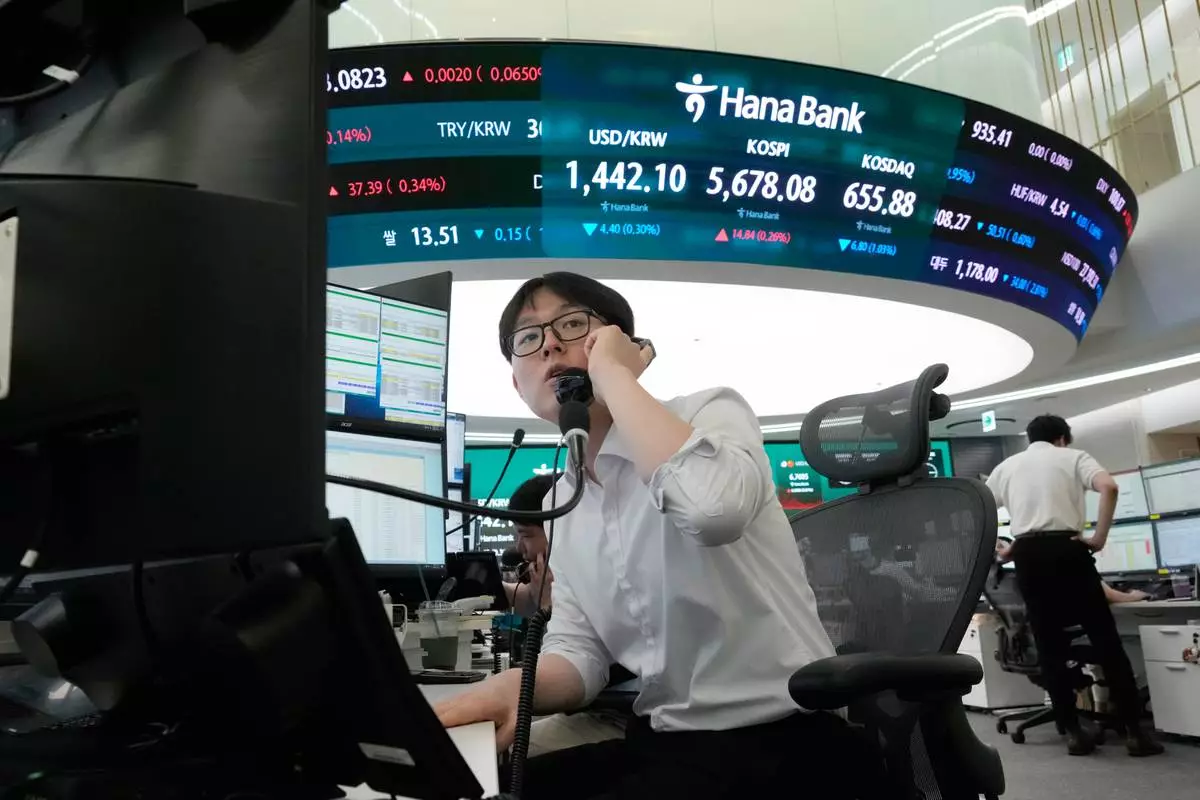A currency trader talks on the phone at the foreign exchange dealing room of the Hana Bank headquarters in Seoul, South Korea, Thursday, July 30, 2026. (AP Photo/Ahn Young-joon)