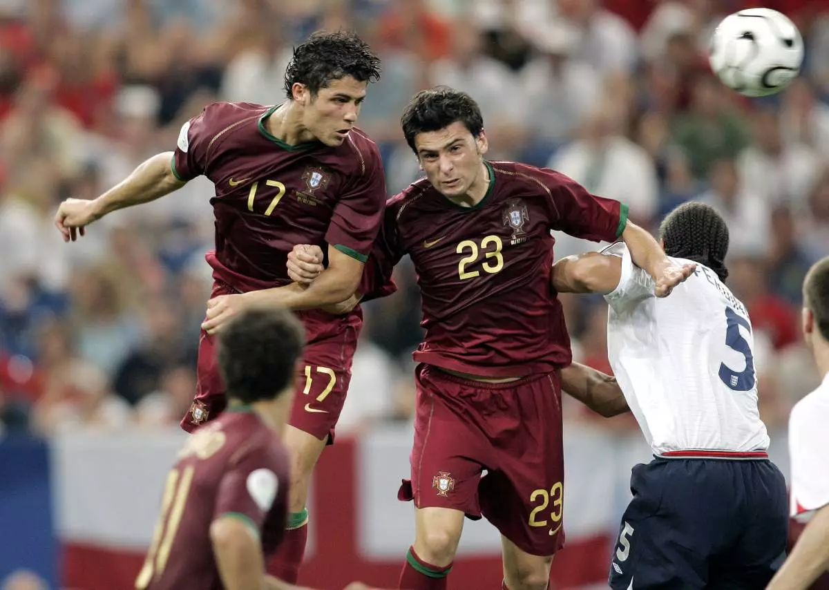 FILE - Portugal's Cristiano Ronaldo, left, and Helder Postiga jump for the ball against England's Rio Ferdinand during a World Cup quarterfinal soccer match in Gelsenkirchen, Germany, July 1, 2006. (AP Photo/Martin Meissner, File)