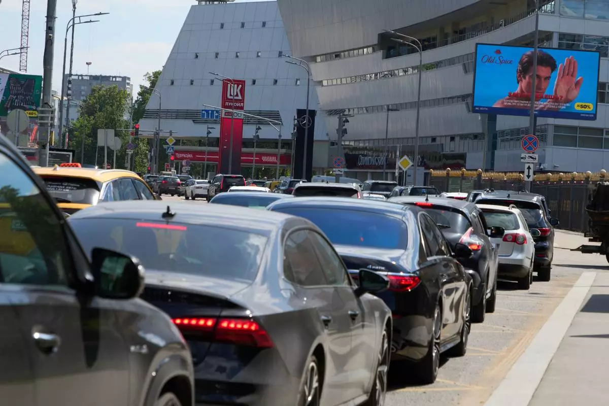 Cars line up at a Lukoil gas station in Moscow, Russia, Tuesday, June 30, 2026. (AP Photo/Alexander Zemlianichenko)