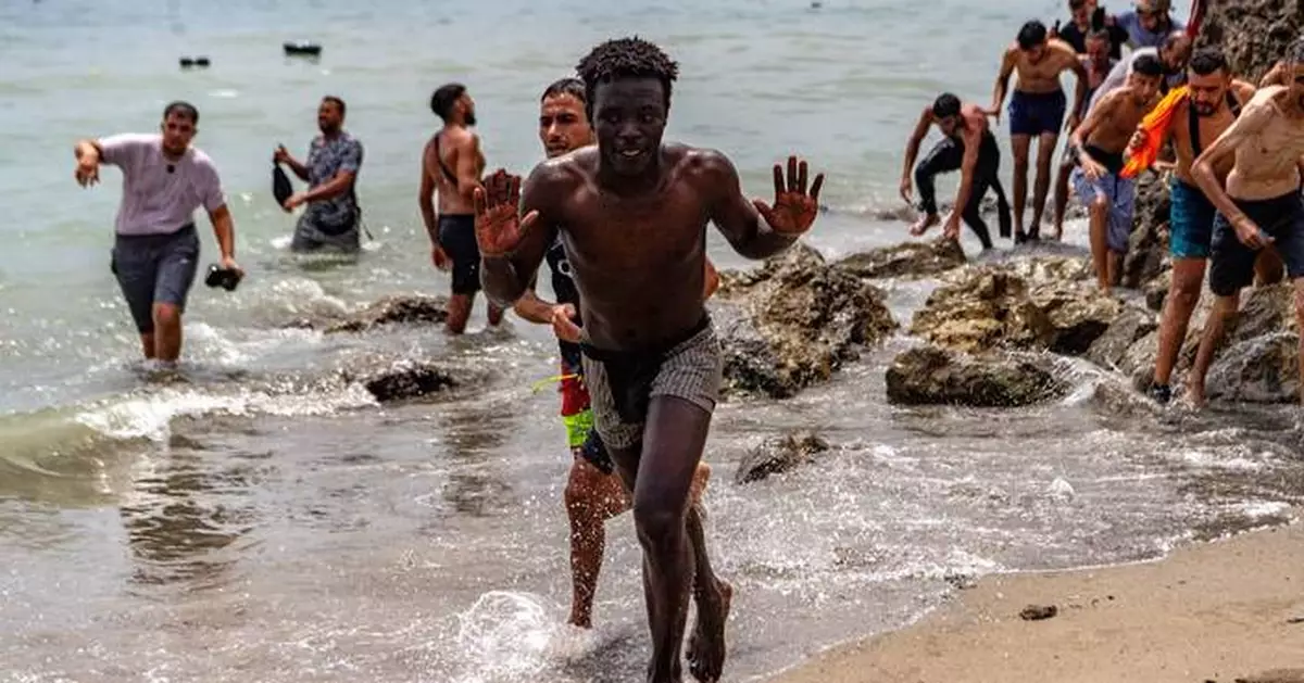 Migrants cross into Spain’s Ceuta enclave from Morocco, in photos