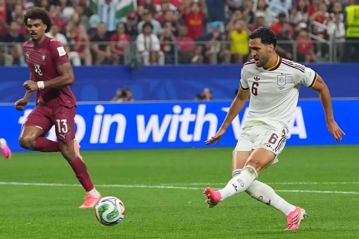 Spain's Mikel Merino (6) scores their first goal during the World Cup round of 16 soccer match between Portugal and Spain in Arlington, Texas, near Dallas, Monday, July 6, 2026. (AP Photo/Julio Cortez)