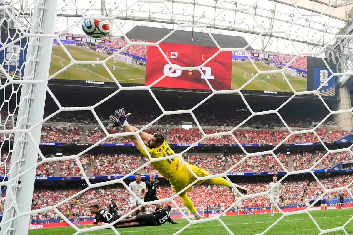 Morocco's Azzedine Ounahi (8) scores their second goal past Canada goalkeeper Maxime Crepeau (16) during the World Cup round of 16 soccer match between Canada and Morocco in Houston, Saturday, July 4, 2026. (AP Photo/David J. Phillip)