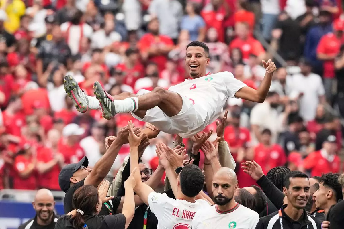 Morocco's Azzedine Ounahi is thrown in the air by his teammates after the World Cup round of 16 soccer match against Canada in Houston, Saturday, July 4, 2026. (AP Photo/David J. Phillip)