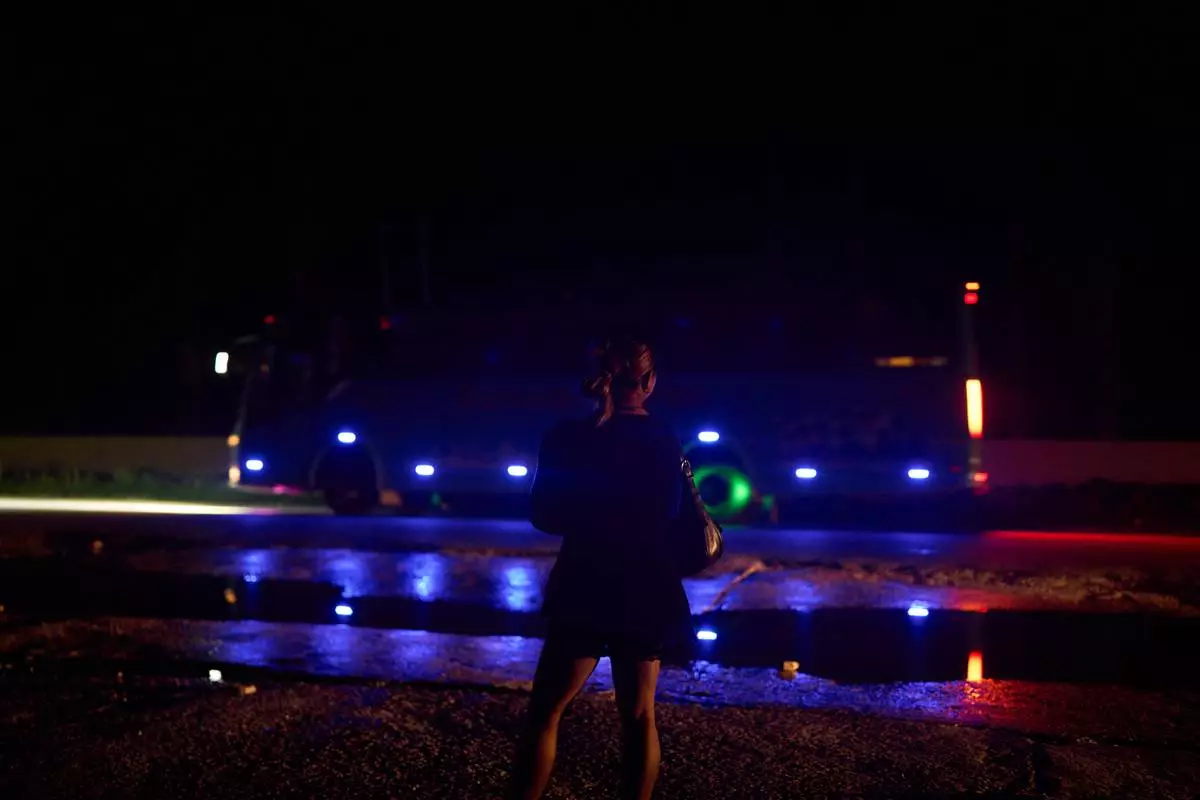 A transgender sex worker stands next to a busy highway waiting for clients to approach her in Hetauda, Nepal, Saturday, May 16, 2026. (AP Photo/Bram Janssen)