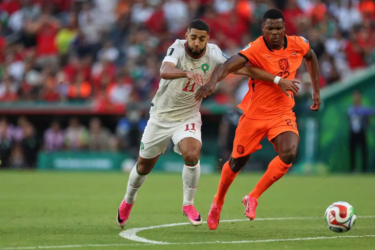 Morocco's Ismael Saibari (11) and Netherlands' Denzel Dumfries (22) battle for the ball during the World Cup round of 32 soccer match between the Netherlands and Morocco in Guadalupe, near Monterrey, Mexico, Monday, June 29, 2026. (AP Photo/Sofia Yaker)