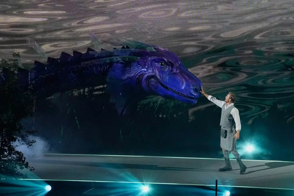 A performer reaches out to touch the mythical Loch Ness monster known as 'Nessie' during the Commonwealth Games opening ceremony in Glasgow, Scotland, Thursday, July 23, 2026. (AP Photo/Manish Swarup)
