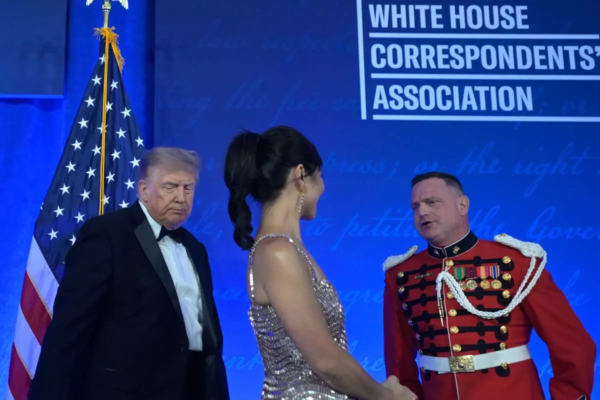 President Donald Trump arrives at the White House Correspondents' Association Dinner, at the Waldorf Astoria Washington DC, Friday, July 24, 2026, in Washington, with WHCA president Weijia Jiang. (AP Photo/Rod Lamkey, Jr.)