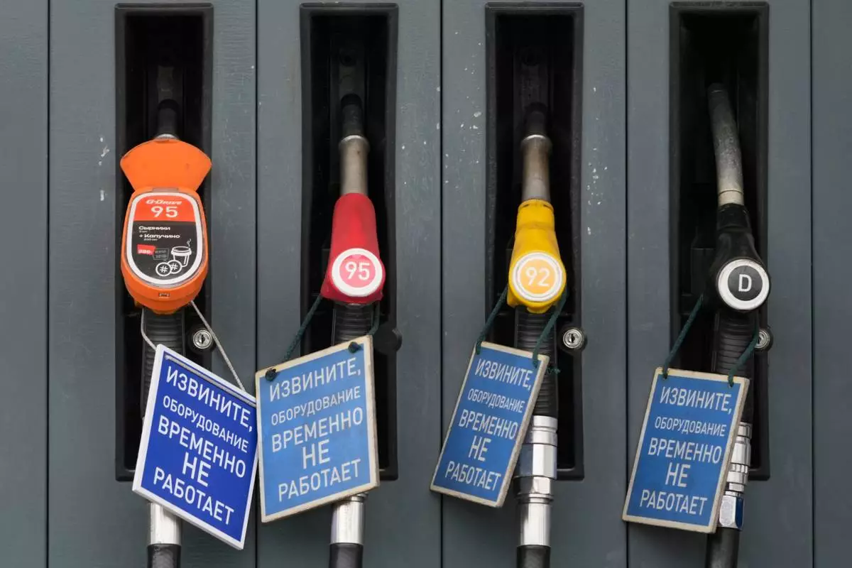 Signs reading in Russian "We are sorry, the equipment is temporarily out of service" are seen on gas pump nozzles at a Gazprom Neft gas station in Moscow, Monday, June 29, 2026. (AP Photo/Pavel Bednyakov)
