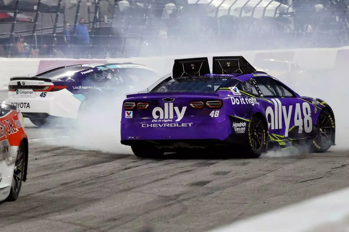 Alex Bowman (48) and Tyler Reddick (45) spin in Turn 2 during a NASCAR Cup Series auto race in North Wilkesboro, N.C., Sunday, July 19, 2026. (AP Photo/Terry Renna)