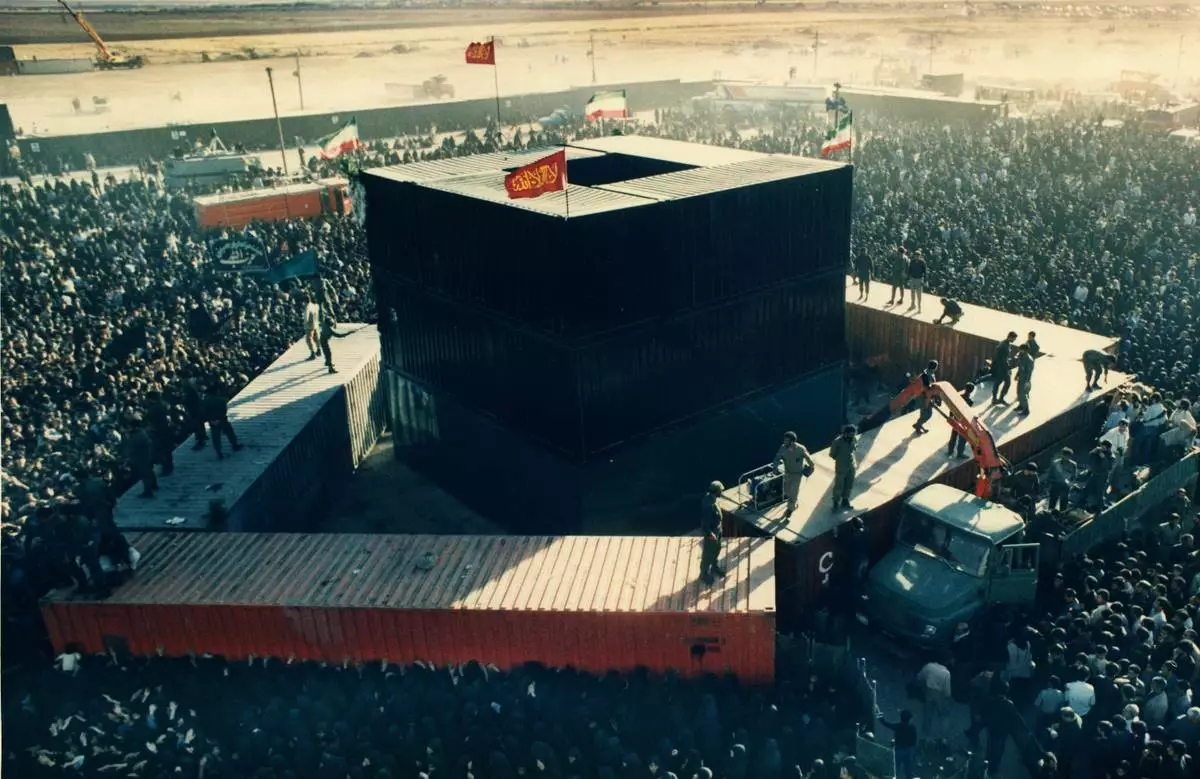 FILE - Mourners crowd around some containers set around the the grave site of the late Ayatollah Khomeini at the cemetery in Beheshte e Zahra, some 70 kms from Tehran, Iran, Sunday June 8, 1989. . (AP Photo/Dusan Vranic, File)