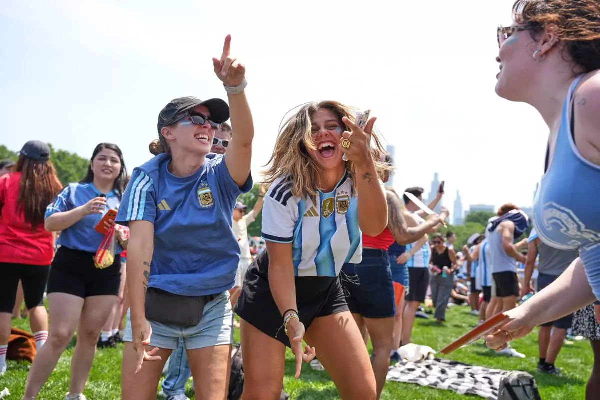 From left, Martina Demaio, Ornella Senarega and Clara Lenger dance during a watch party in Central Park ahead of the World Cup final soccer match between Argentina and Spain, Sunday, July 19, 2026, in New York.(AP Photo/Anna Connors)
