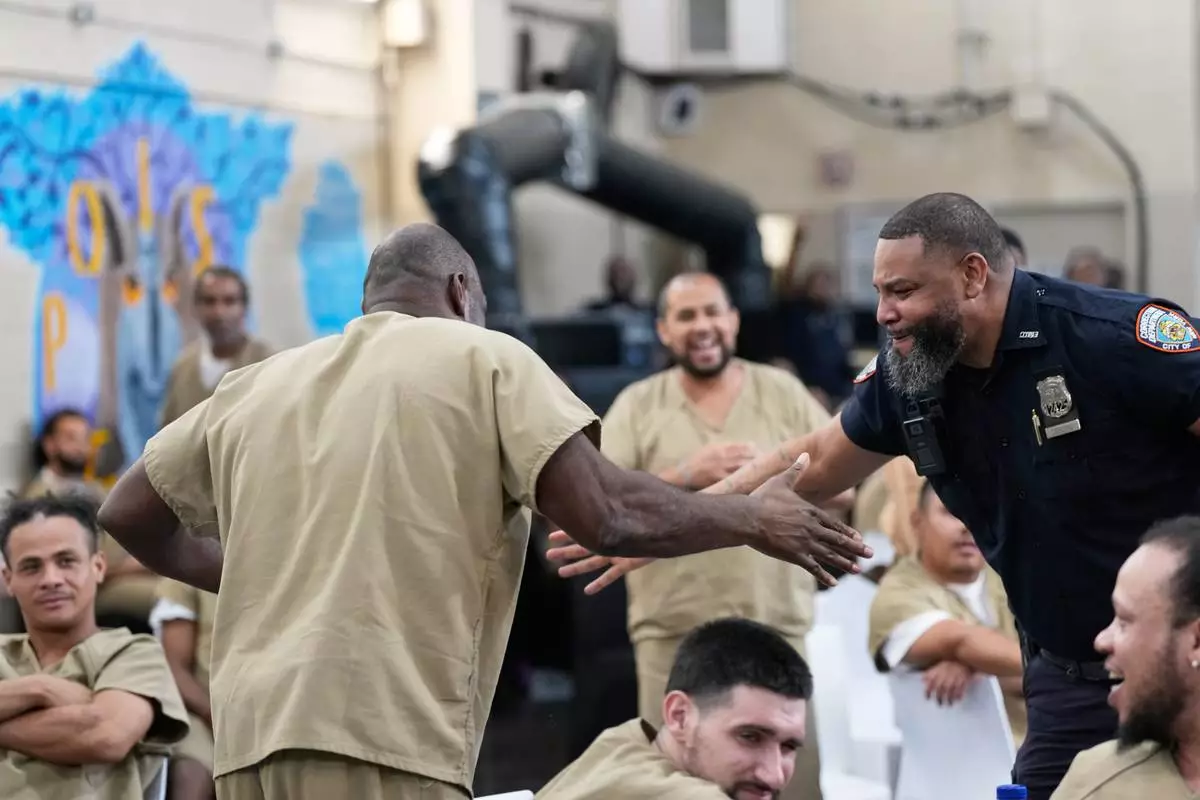 Rikers Island inmate Ralph Veal celebrates an English goal with a corrections officer during the World Cup semifinal soccer match between England and Argentina, at the jail complex in New York, Wednesday, July 15, 2026. (AP Photo/Seth Wenig)