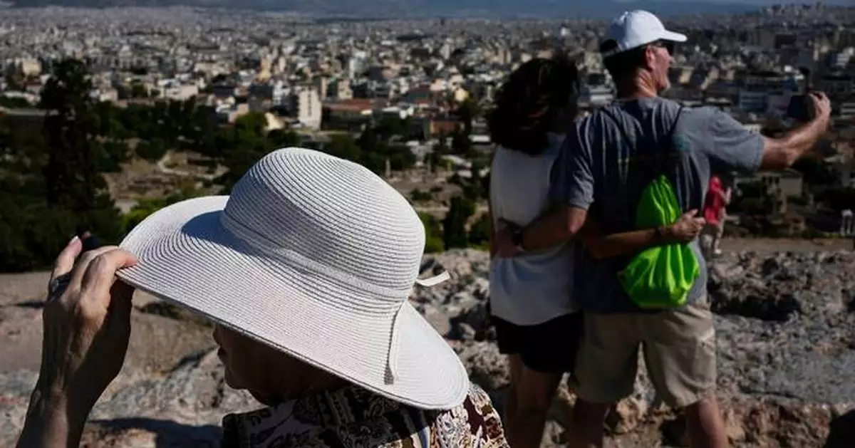 The sunhat is everywhere in Athens as crowds grow larger at ancient sites