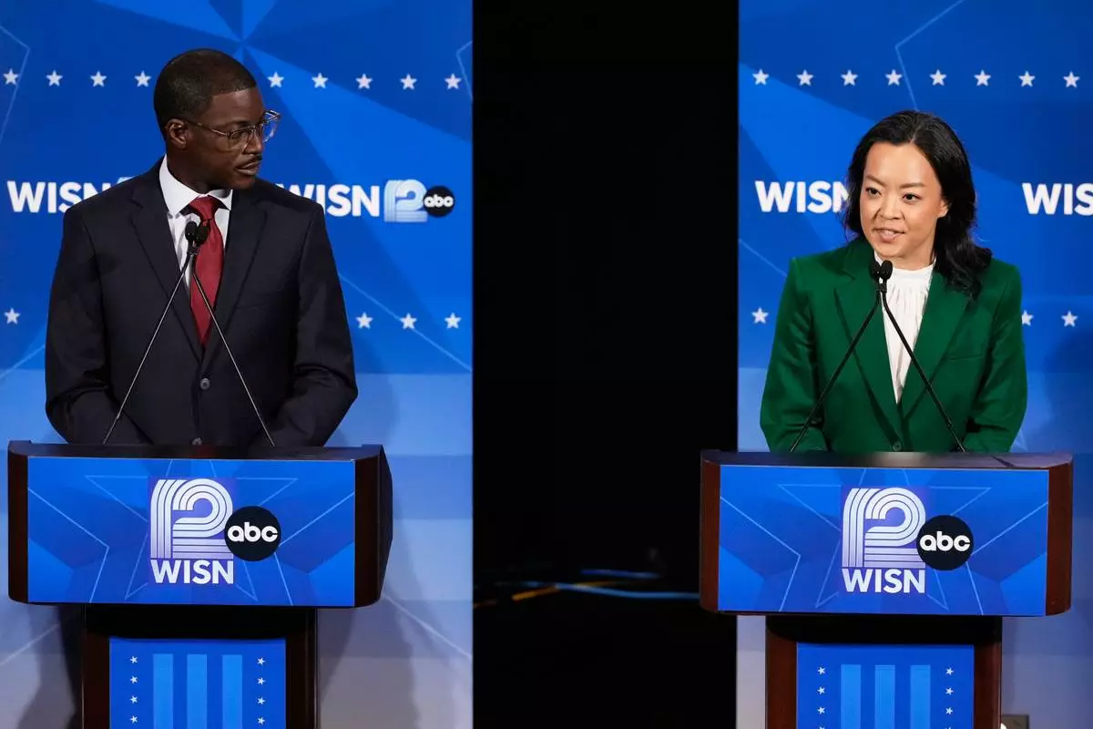 Democratic gubernatorial candidate Francesca Hong, right, talks as David Crowley listens during a primary debate in Milwaukee, Tuesday, July 28, 2026. (AP Photo/Nam Y. Huh)