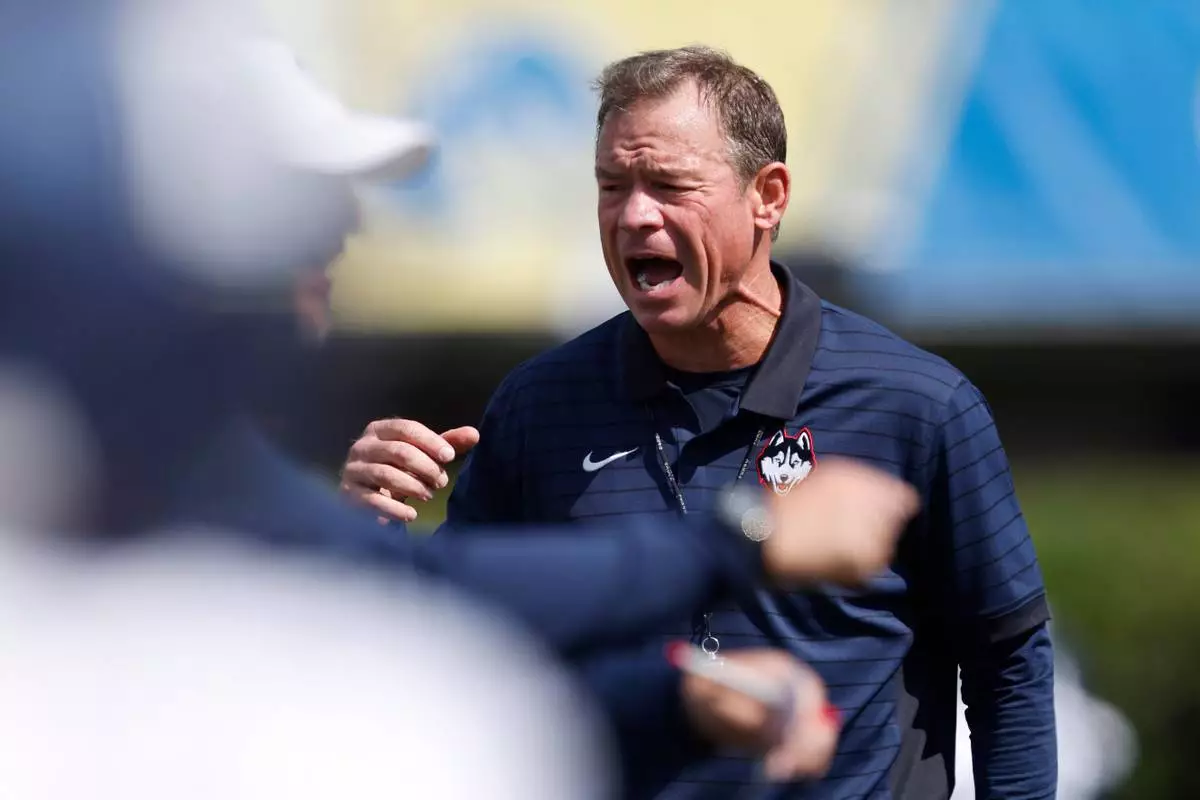 UConn head coach Jim Mora encourages his players before an NCAA football game against Delaware on Saturday, Sept. 13, 2025, in Newark, Del. (AP Photo/Mike Buscher)