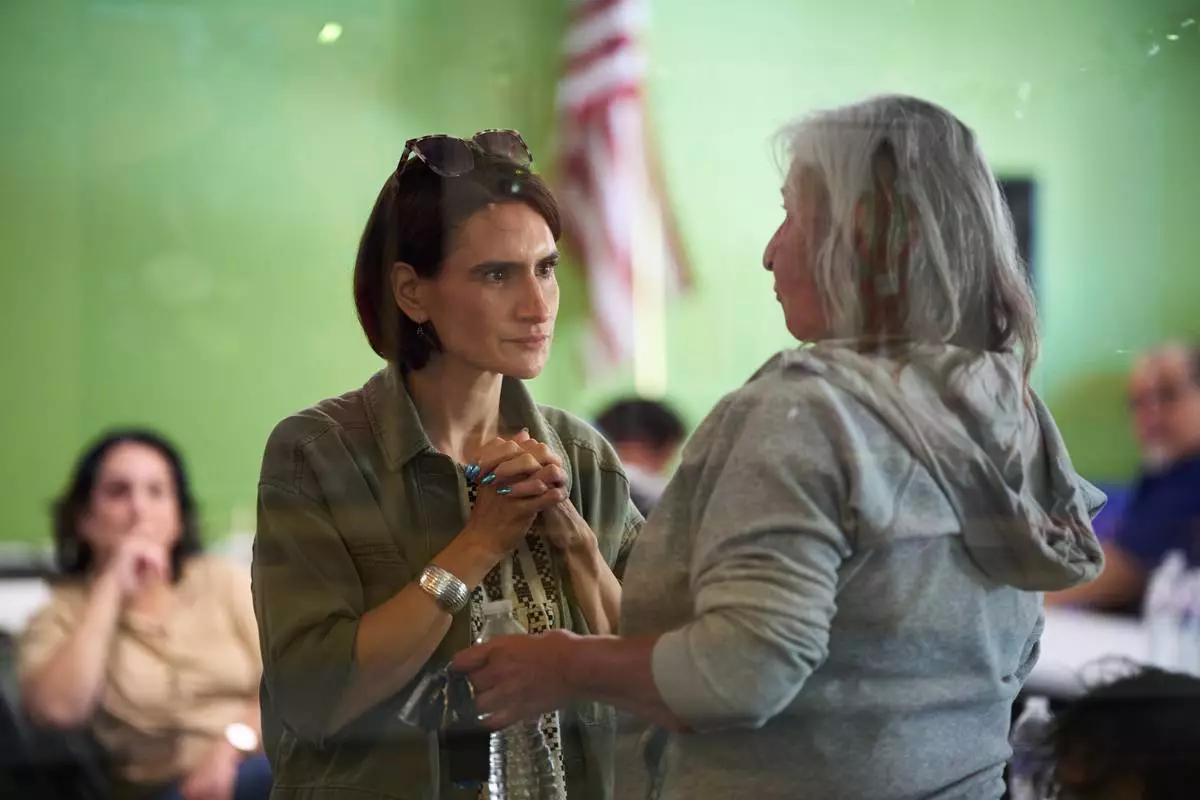 Minnesota Lt. Gov. Peggy Flanagan, a Democratic candidate for U.S. Senate, listens to a voter during a campaign event at the Leech Lake Band of Ojibwe Twin Cities Office in Minneapolis, Saturday, Aug. 8, 2026. (AP Photo/Ellen Schmidt)