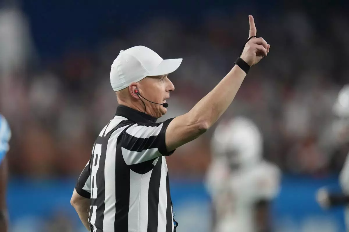 FILE - Referee Ron Snodgrass calls second down during the first half of the Fiesta Bowl NCAA college football playoff semifinal game between Miami and Mississippi, Thursday, Jan. 8, 2026, in Glendale, Ariz. (AP Photo/Ross D. Franklin, File)