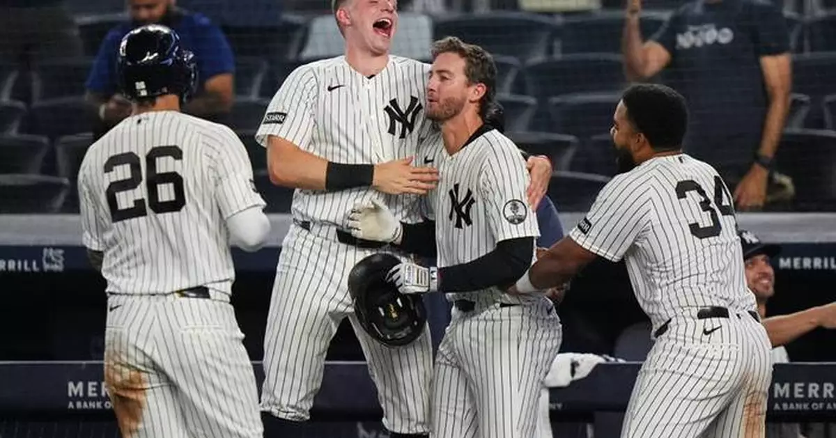 Yankees rally with 2 outs in 9th inning and beat Braves 3-2 in 10 after long rain delay