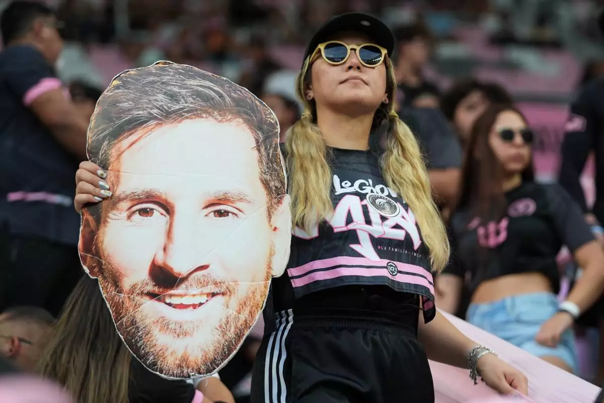 A fan holds a cutout face of Inter Miami forward Lionel Messi before a Leagues Cup soccer match between Inter Miami and Monterrey, Saturday, Aug. 8, 2026, in Miami. (AP Photo/Lynne Sladky)