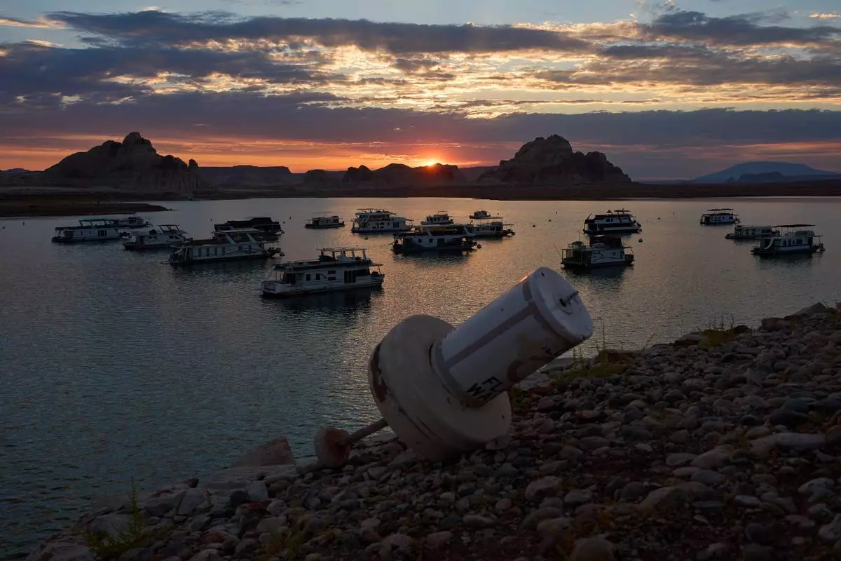 FILE - A formerly floating buoy now sits high and dry above Lake Powell at the Glen Canyon National Recreation Area, July 15, 2026, near Page, Nev. (AP Photo/John Locher, File)